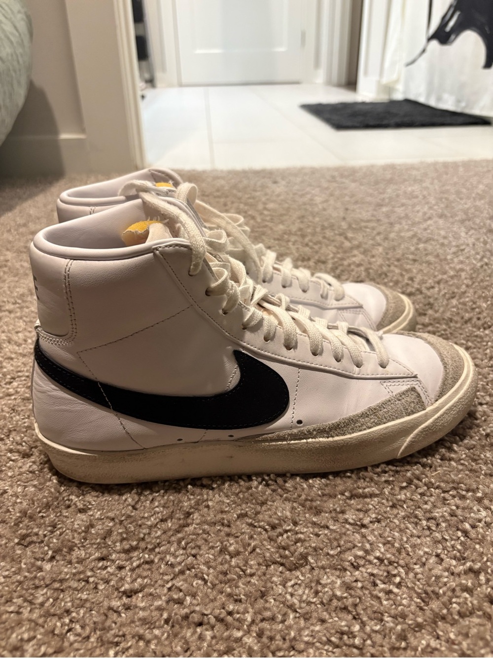 Nike White High-Top Sneakers with Black Swoosh